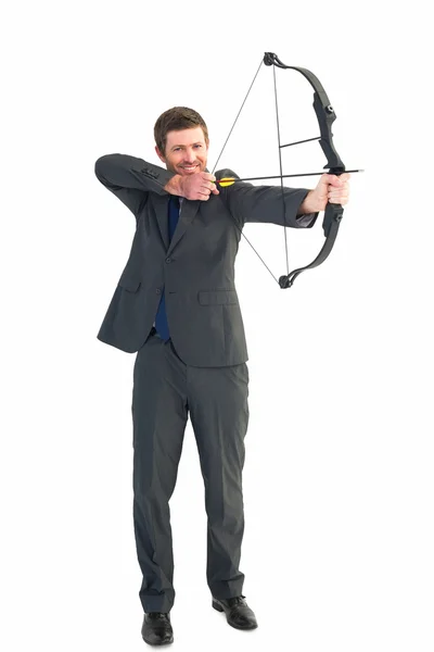 Businessman shooting a bow and arrow — Stock Photo, Image