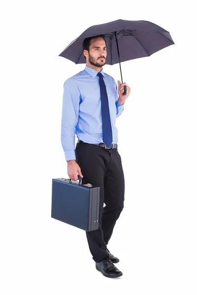 Uomo d'affari in tuta con ombrello e valigetta — Foto Stock