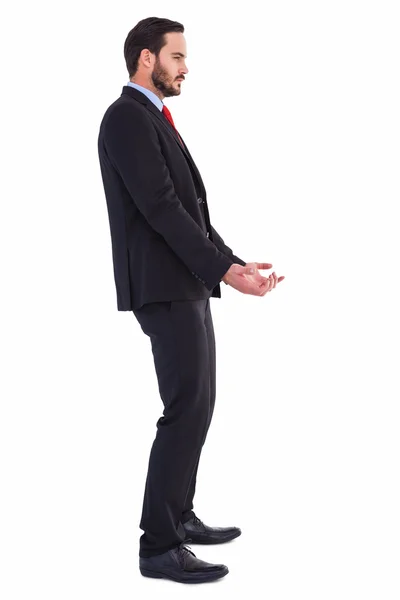 Uomo d'affari non sorridente che tiene qualcosa con le mani — Foto Stock