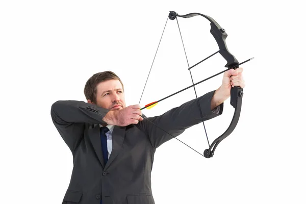 Focused businessman shooting a bow and arrow — Stock Photo, Image