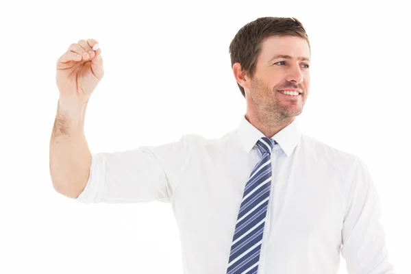 Smiling businessman writing something with white chalk — Stock Photo, Image