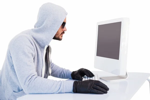 Serious burglar hacking into laptop — Stock Photo, Image