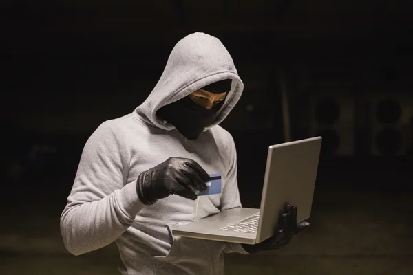 Hacker using laptop to steal identity — Stock Photo, Image