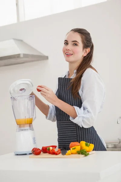 Pretty brunette making a healthy juice — Stock Photo, Image