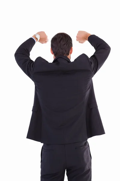 Задний план бизнесмена, стоящего с поднятыми руками — стоковое фото