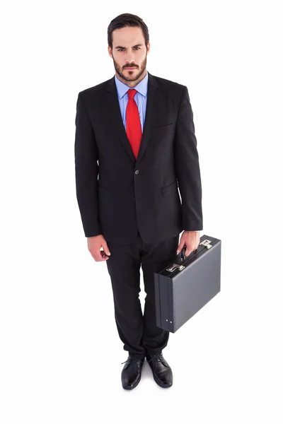Serious handsome businessman holding briefcase — Stock Photo, Image