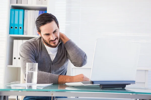 Frowning handsome businessman having neck pain — Stock Photo, Image