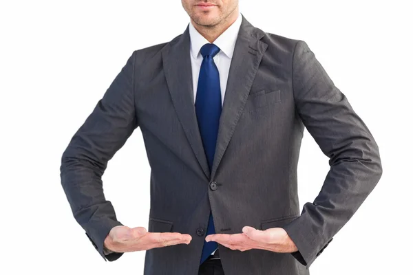 Businessman presenting your product with hands — Stock Photo, Image