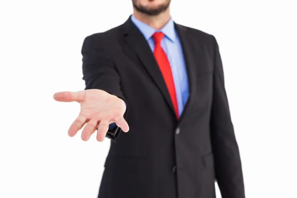 Businessman holding hand out in presentation — Stock Photo, Image