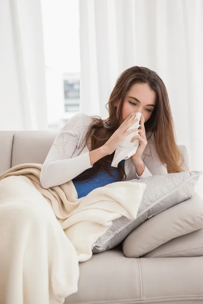Sick brunette on the couch — Stock Photo, Image