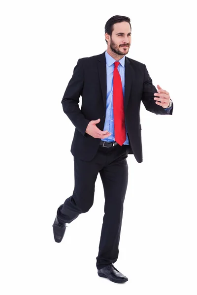 Smiling young businessman in suit running — Stock Photo, Image