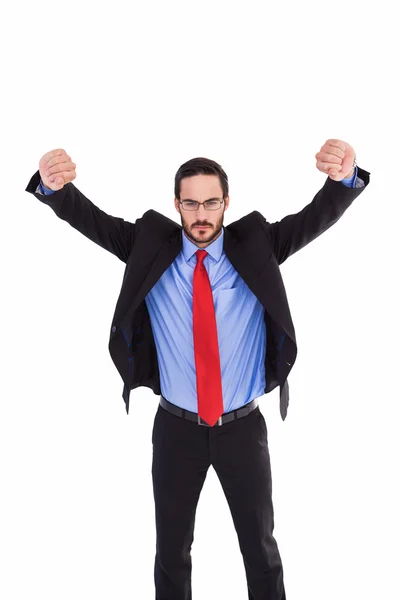 Hombre de negocios no sonriente de pie con los brazos levantados —  Fotos de Stock