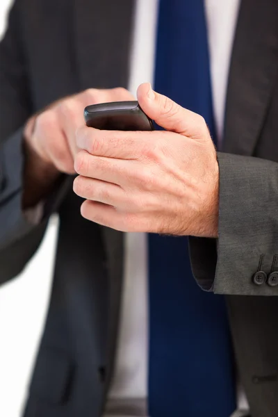 Wysyłanie SMS-ów biznesmen koncentruje się na jego telefon komórkowy — Zdjęcie stockowe