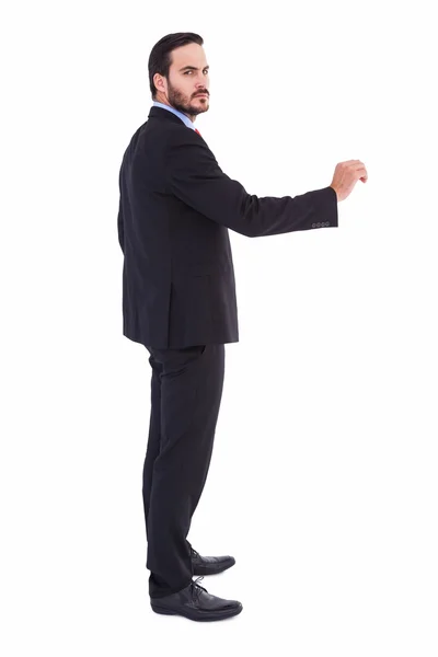 Serious businessman standing with arms raised — Stock Photo, Image