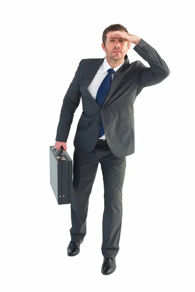 Businessman looking with his briefcase — Stock Photo, Image