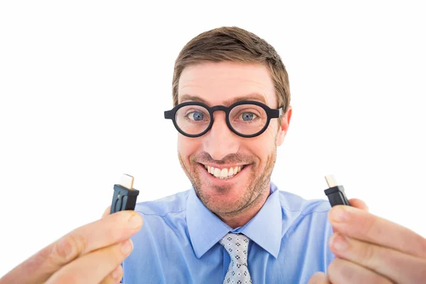 Geeky businessman holding two cables — Stock Photo, Image