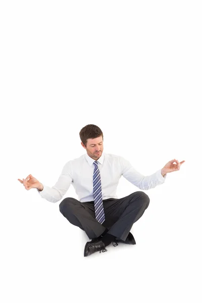 Businessman in suit sitting in lotus pose — Stock Photo, Image