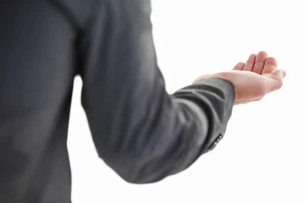 Businessman holding hand out in presentation — Stock Photo, Image