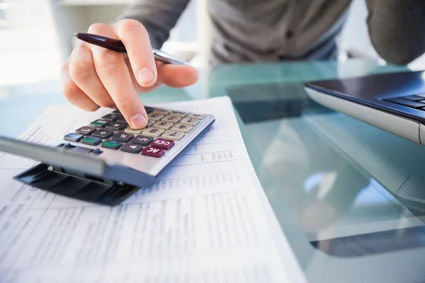 Empresário ocasional calcula as suas despesas — Fotografia de Stock