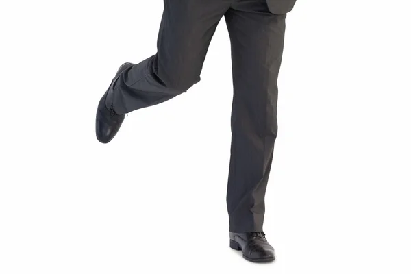 Handsome businessman in suit stepping — Stock Photo, Image