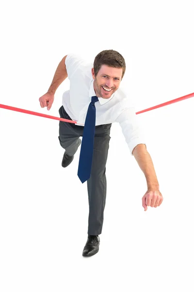 Businessman crossing the finish line — Stock Photo, Image