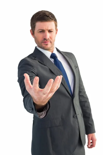 Businessman holding out his hand — Stock Photo, Image