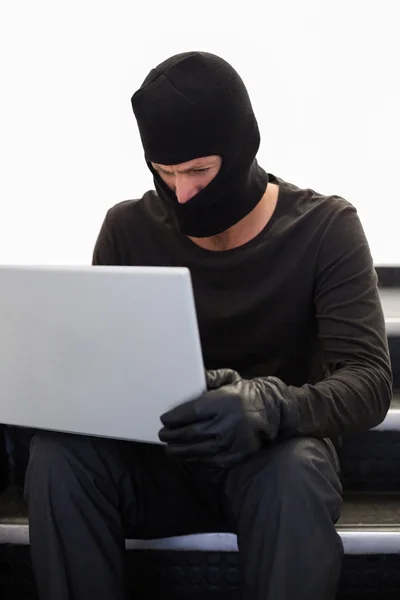 Hacker using laptop to steal identity — Stock Photo, Image