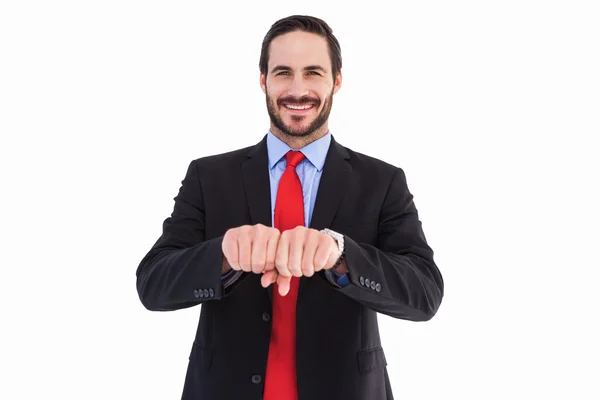 Un hombre de negocios sonriente con el puño cerrado delante de él — Foto de Stock