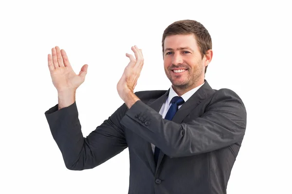 Smiling businessman showing something with his hands Stock Picture