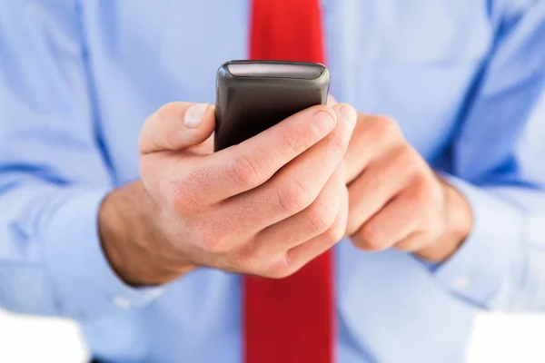 Businessman texting on his mobile phone — Stock Photo, Image