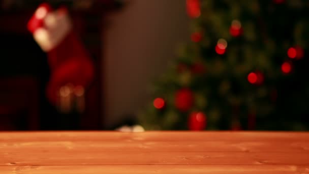 Empty table against blinking lights on christmas tree — Stock Video