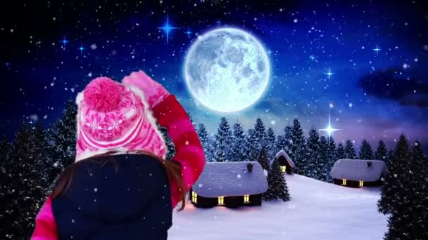 Kleines Mädchen winkt dem Weihnachtsmann zu, der über das Dorf fliegt — Stockvideo