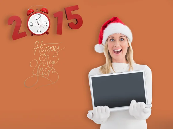 Festive blonde showing a laptop — Stock Photo, Image