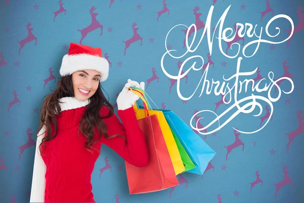 Festive brunette holding shopping bags — Stock Photo, Image