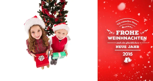 Festive little siblings smiling at camera — Stock Photo, Image