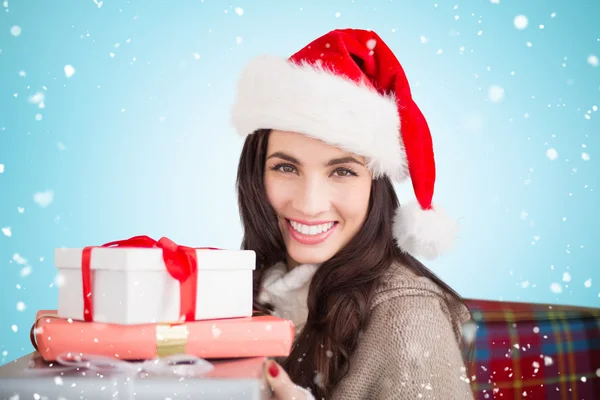 Festive brunette holding gifts — Stock Photo, Image