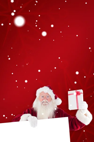 Santa shows present — Stock Photo, Image