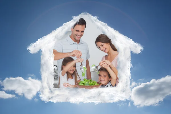 Family mixing a salad together — Stock Photo, Image