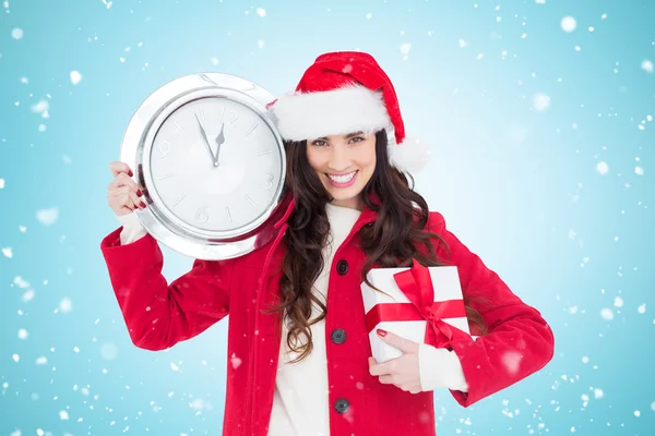 Brune festive tenant horloge et cadeau — Photo