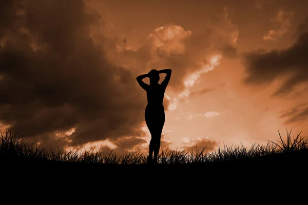 Fit brunette against cloudy sky — Stock Photo, Image