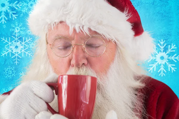 Santa drinks from red cup — Stock Photo, Image
