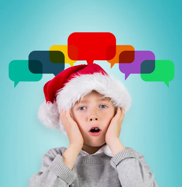 Festive surprised boy in santa hat — Stock Photo, Image