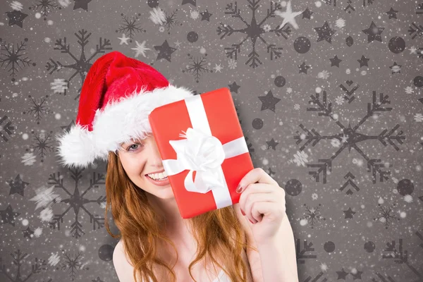 Festive redhead holding gift — Stock Photo, Image