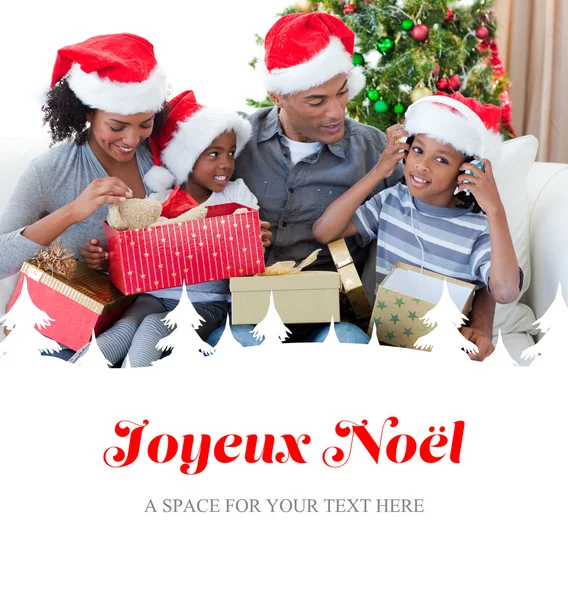 Happy family playing with christmas presents — Stock Photo, Image