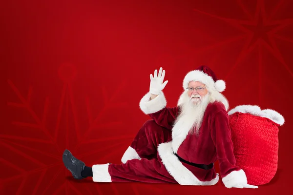 Babbo Natale si siede appoggiato su borsa e onde — Foto Stock