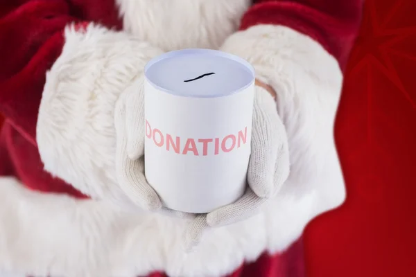 Santa rymmer kan för donationer — Stockfoto