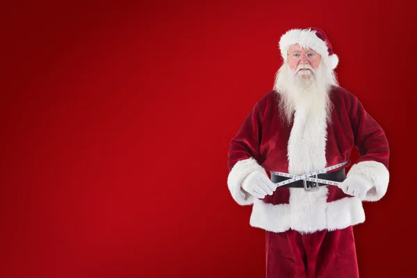 Santa Claus measures his belly — Stock Photo, Image