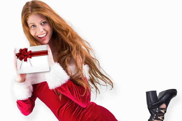 Festive redhead holding gift — Stock Photo, Image