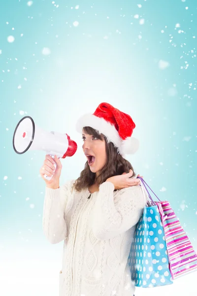 Brunette holding megaphone and bags — Stock Photo, Image