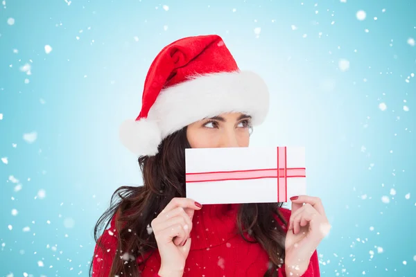 Festive brunette holding a gift — Stock Photo, Image